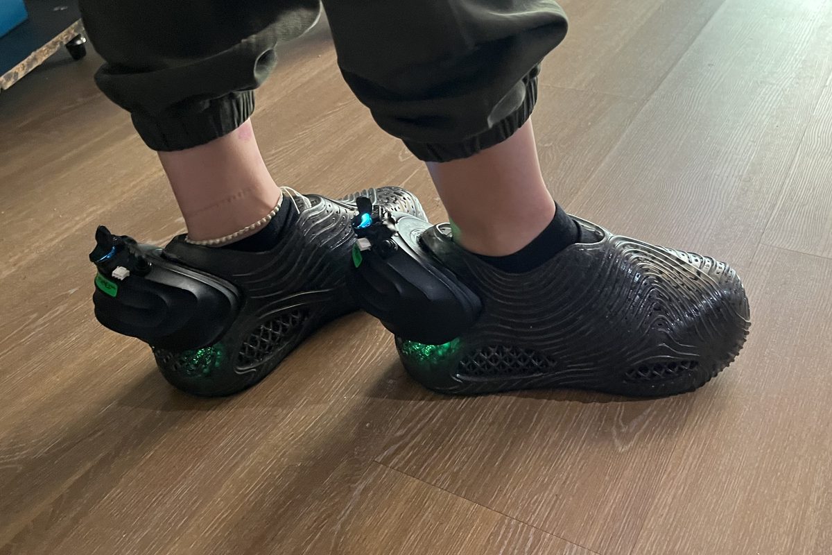 The GroundWaves MVP sneakers being worn, glowing green at the heel